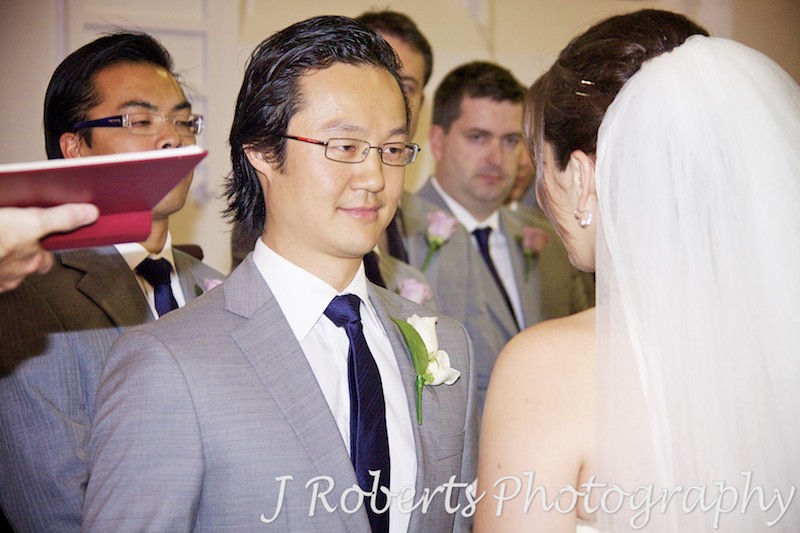 Groom smiling at bride during ceremony - wedding photography sydney